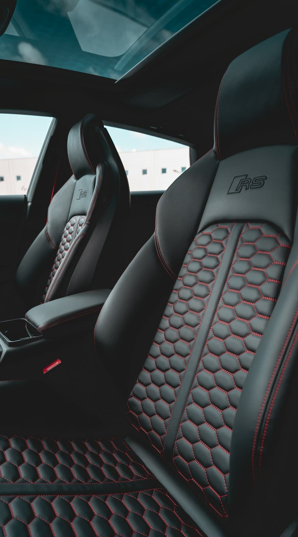 Black sport seats with red hexagon stitching